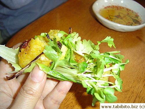 A piece of the Banh Xeo and herbs are wrapped in a lettuce leaf and dipped in nuoc cham, really really yum!