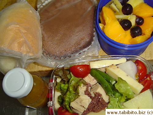 Tuna and cheese salad, roll, chocolate sponge cake, mango, kiwi and blueberries