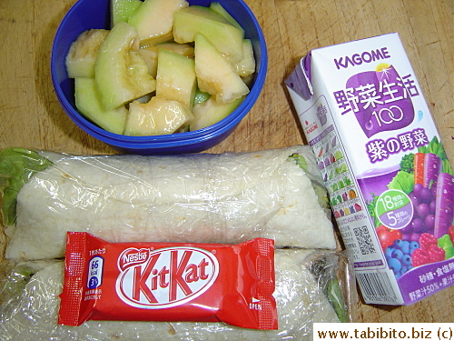 Ham and cream cheese wraps, KitKat, juice, melon