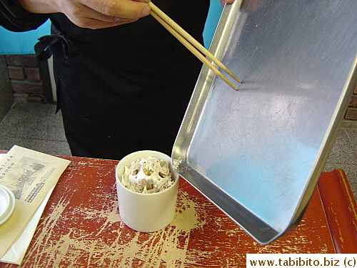 Then he swept the fine powdery bits into the urn with chopsticks 