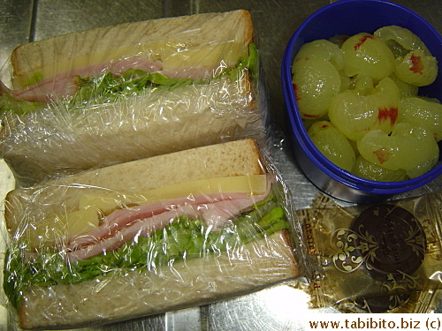 Ham and cheese sandwich, grapes, chocolate