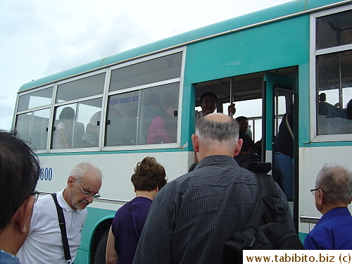 Boarding a bus to ride a very short distance (30 seconds?) to the building entrance