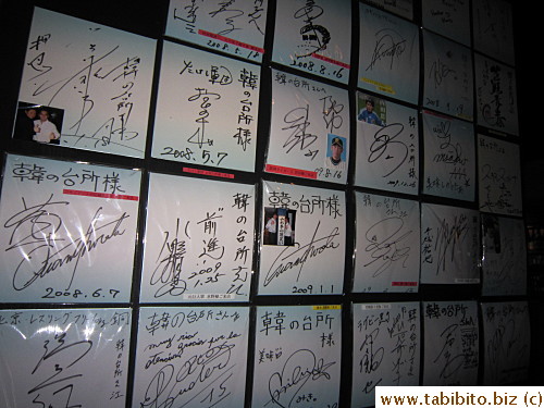 Signed autographs of famous customers adorn the wall