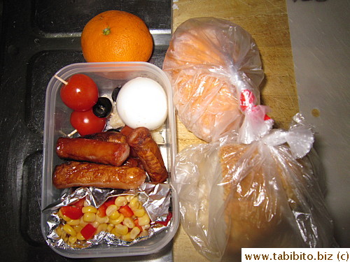 Corn and red pepper salsa, sausages, cherry tomato/olive/Parmesan cheese sticks, soft-boiled egg, rolls, mandarin