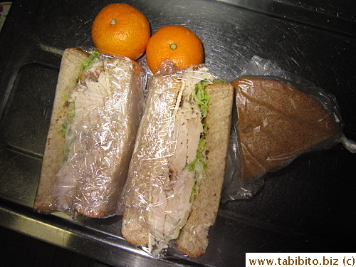 Chicken sandwich, chocolate cake, mandarin