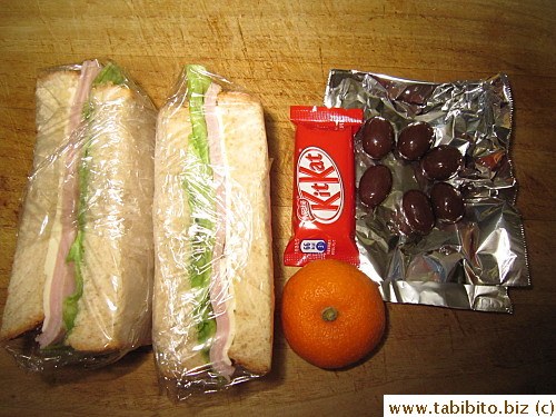 Ham and cheese sandwich, mandarin, KitKat, chocolate almond