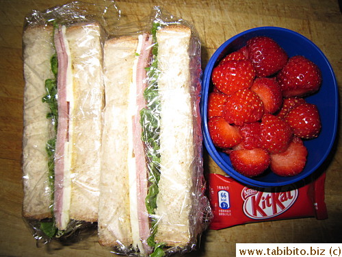 Ham and cheese sandwich, strawberries, KitKat
