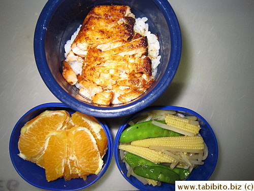 Grilled salmon, stirfried snow peas, bean sprouts and baby corn, orange