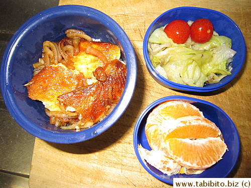 Teriyaki salmon, sauteed lettuce, cherry tomatoes, orange