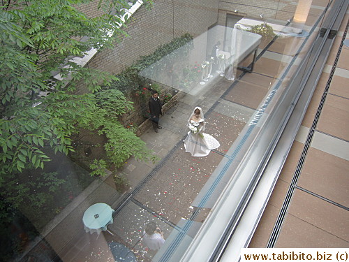 Wedding couple having their photos taken outside the restaurant on the underground floor