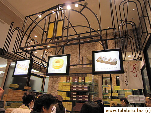 Five people at the counter serving customers