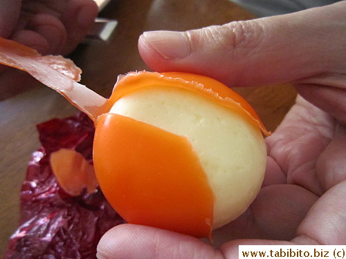 Peel away the waxy shell reveals creamy cheese color