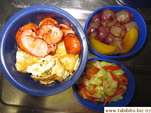 Sausages, egg roll, sauteed cabbage and red peppers, plum and grapes