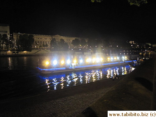 A boat on river Seine lit up the water
