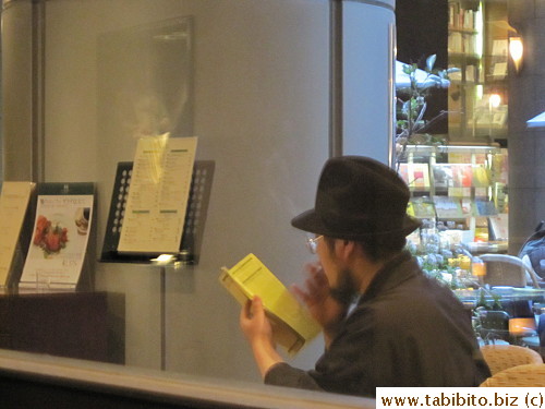 I like this image of the bearded Japanese man wearing a kimono and fedora with a cigarette between his fingers studying the menu