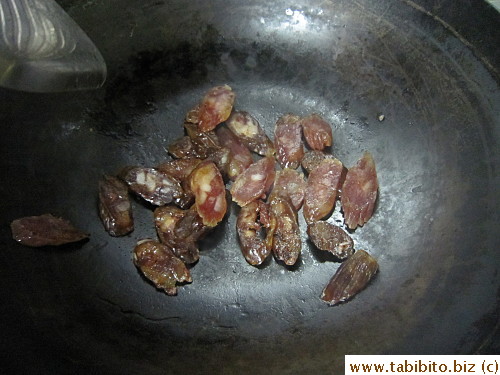 Dry-frying the Chinese sausages