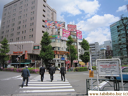 The restaurant is just around the building from the crossing outside the station