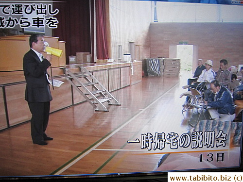 Evacuees who are to retrieve vehicles from the evacuation zone attend a seminar before the actual trip