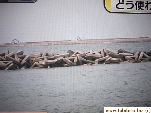 The other type of barrier wall on the coast is destroyed by the tsunami