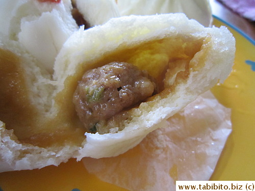 The filling in minced pork bun is a small meat ball with little veggies inside