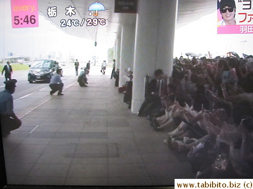 Japanese police are sooooo considerate: they duck down just before the car approaches so they don't block the fan's view