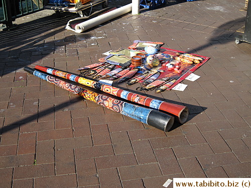 An Aborigine took a break from performing and selling goods at the Quay