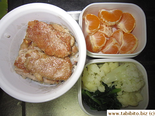 Fried pork chop, stirfried cauliflower, sauteed spinach with garlic, mandarin