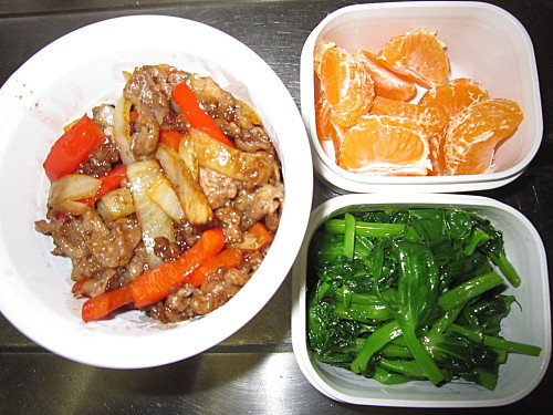 Stirfried beef with onion and red peppers, sauteed pea shoots, mandarin
