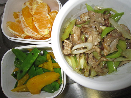 Stirfried pork with garlic shoots, sauteed sugar snap peas and yellow pepper, orange
