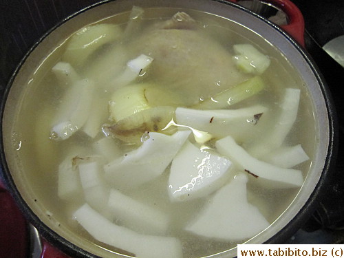 Prepped ingredients go into the pot of boiling water