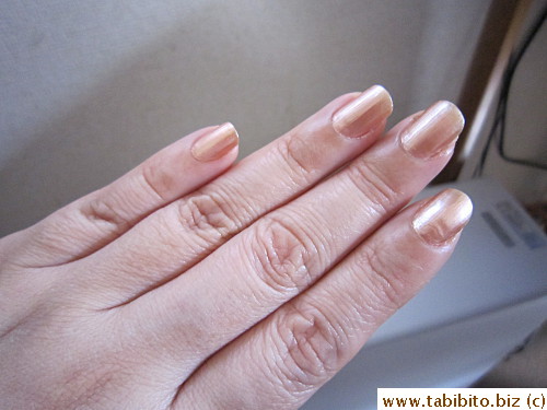 Under bright light by the window, it looks pinkish