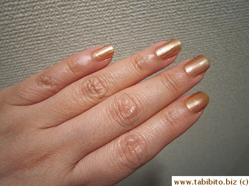 In the bathroom under a yellow bulb, it changes to a warm bronze