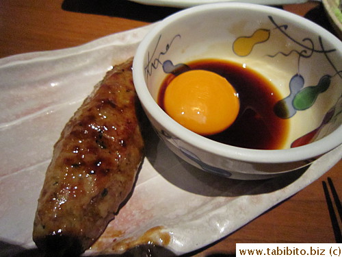 Grilled minced chicken on a stick served with egg yolk
