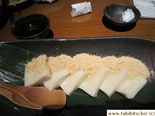A dessert made with tofu sprinkled with soy bean powder served with syrup. We were told it was a little chewy but turns out they were totally not