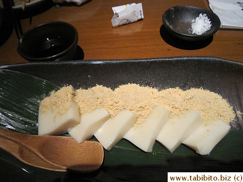 A dessert made with tofu sprinkled with soy bean powder served with syrup.  We were told it was a little chewy but turns out they were totally not