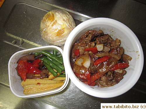 Stirfried beef with onion and red peppers, sauteed green beans and baby corn, orange