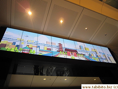 One of several large screens showing animation