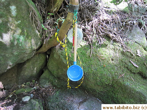A big water scoop is provided for people to catch water to wash hands (or to drink?)