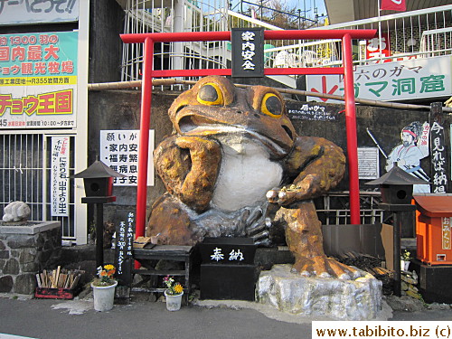 Another big frog statue on the ground