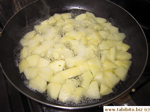Boiling apple cubes in water till they're soft