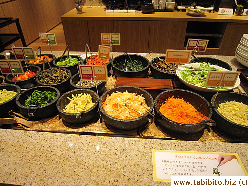 At the buffet table, there's veggies