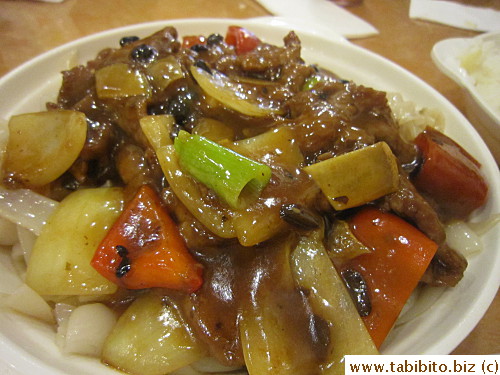 Beef and bell peppers over noodles