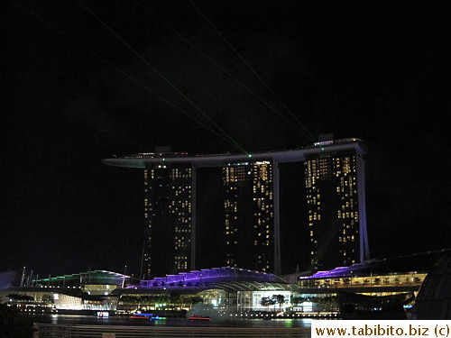 Laser beams shoot out from top of the building during the light show