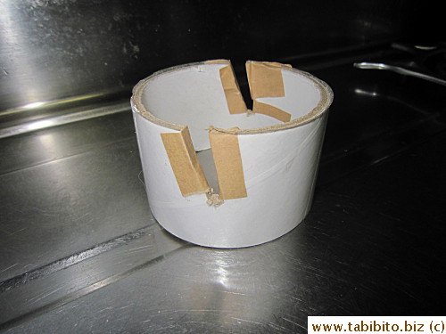 Cut two slanted slits on an empty tape roll and you've got an iPad stand