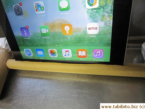 Stick your iPad where the microphone is into the slit,