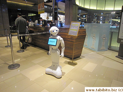 Robot greets people in Q Square